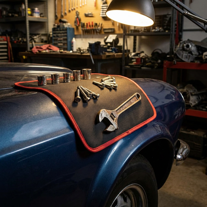 Magnetic tool mat draped on fender with tools gripped