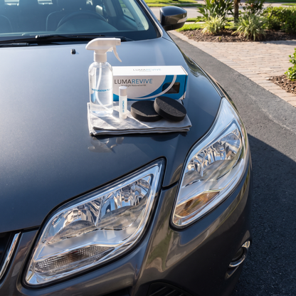 LumaRevive Headlight Restoration Kit lifestyle shot on car hood next to clear headlights